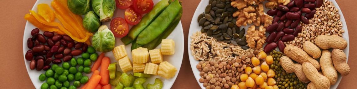 Vibrant display of assorted vegetables, legumes, nuts, and seeds on plates, perfect for healthy eating images.